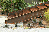 Mid-century industrialism is exemplified here with the custom steel stair connecting the upper and lower terrace areas.