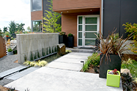 A sense of arrival is elongated and accentuated with a slight jog in the entry pathway.  Containers are from Ragen & Associates.