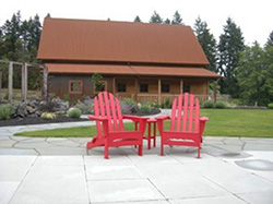 Patio for dining and lawn for gatherings framed by the dairy_equipment barn