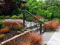 Custom wrought iron handrail repeats architectural details of the house
