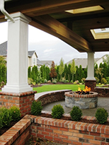 Sheltered patio by Vanessa  Gardner Nagel - highlighting fire pit, raised planters, seat walls and a framed view of the garden