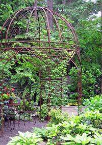 The owner added this gazebo to the woodland creating a destination not far from the new koi pond.